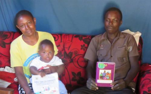During a home visit, Survival parents learn about developmental milestones for their son, James.