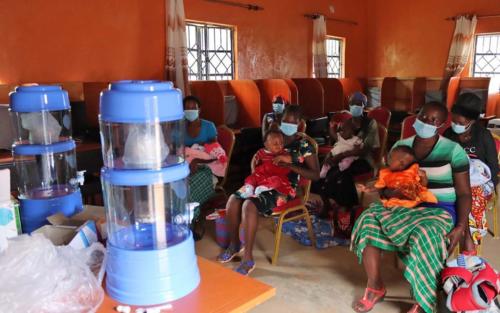 Caregivers receive water filters and storage tanks for their families. They learn how to use the filter, and how the filtration system can prevent waterborne illness.
