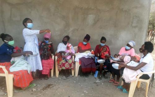 During a group meeting at the church, caregivers learn about displaying positive emotions and actions to set a good example for their children.
