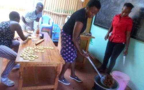 Mothers gather at the church for a group meeting. They learn various income-generating skills that will help them support their families.