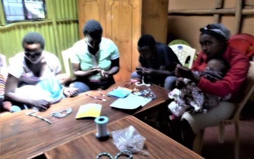 Caregivers learn the skill of beading and how to create different objects to sell such as necklaces, ornaments, baskets and purses.